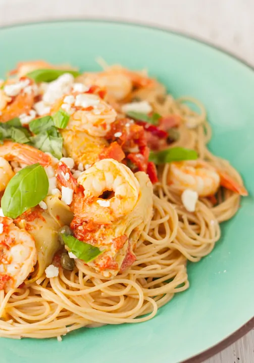 Creamy Shrimp Pasta with Artichokes and Roasted Red Peppers served on a plate