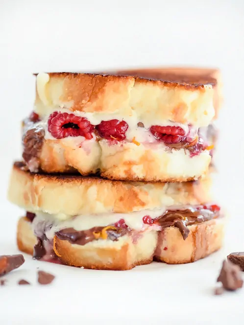 Two Raspberry and Chocolate With Almonds Grilled Cheeses stacked together