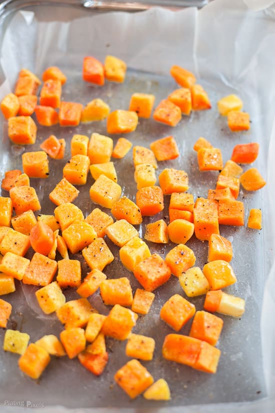 Roasted cubed sweet potato in a baking dish used for making breakfast tacos 