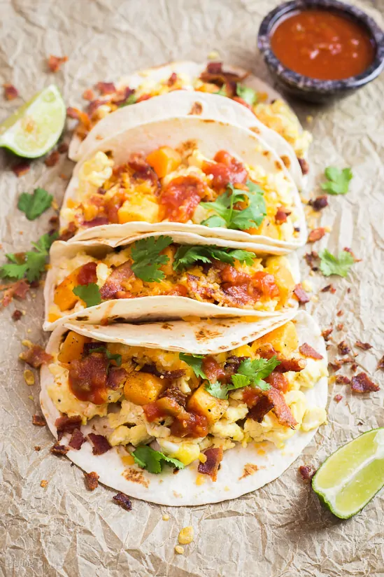 Sweet Potato Breakfast Tacos stacked together with salsa in the background