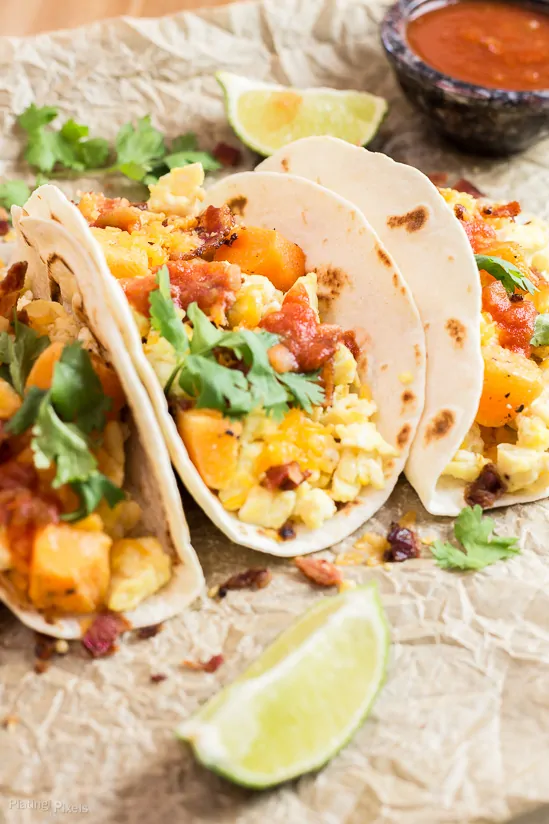 A close up of Sweet Potato Breakfast Tacos sitting on brown paper