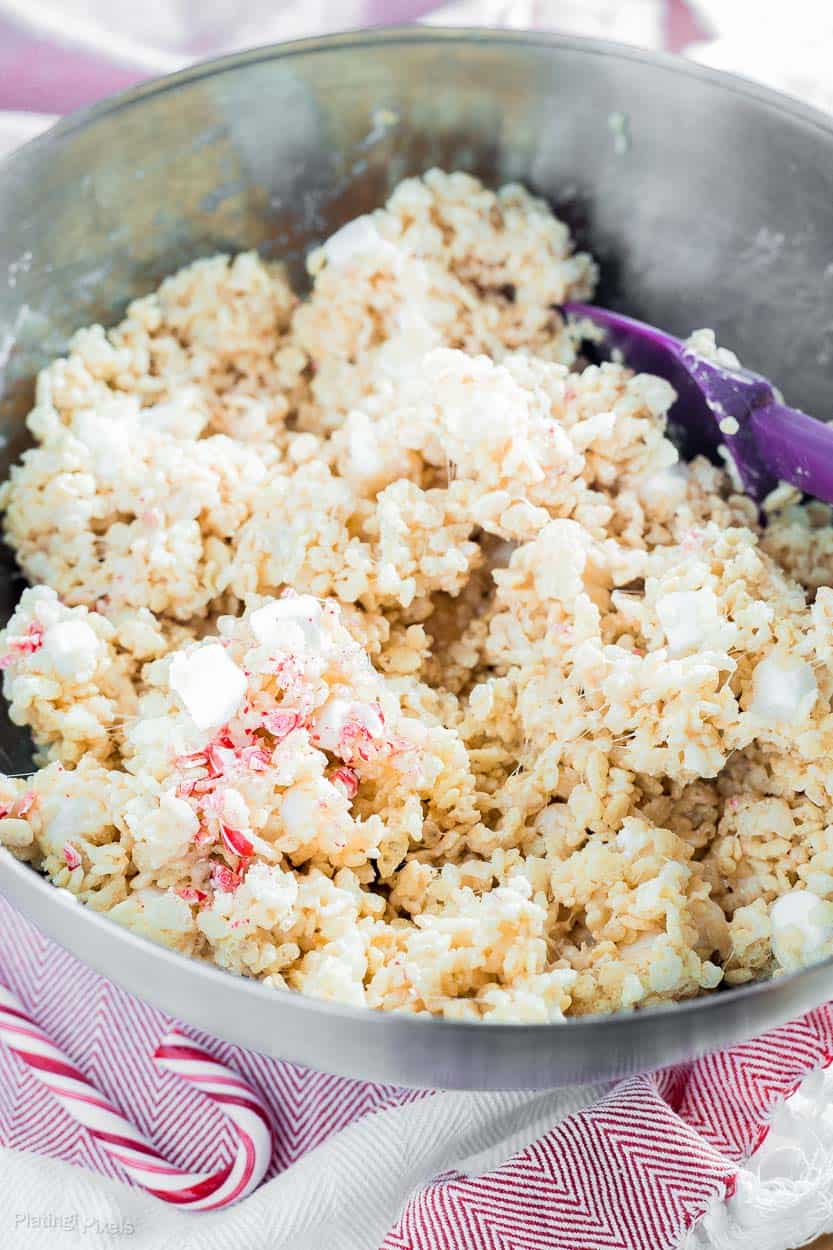 Stirring together Pepper Rice Krispie Treats mixture in a metal bowl