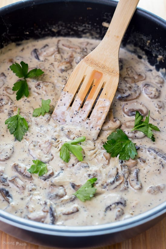 A close up of Mushroom Wine Sauce in a pan topped with fresh parsley