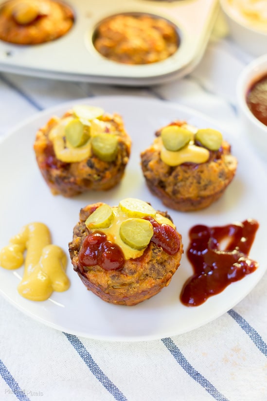  Mini Cheeseburger Muffins on a plate with pickles and ketchup