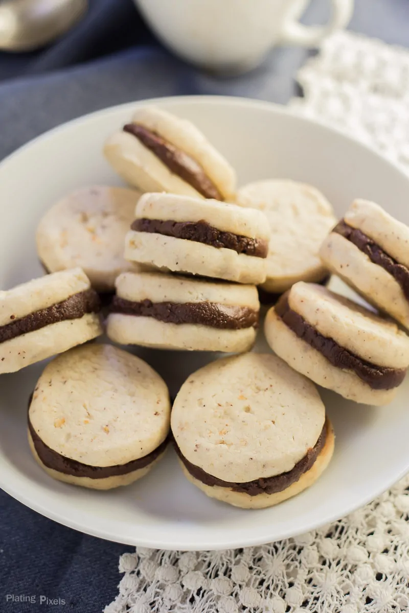 Close-up of assembled Pumpkin Spice Chocolate Shortbread Cookies sandwiches on a plate