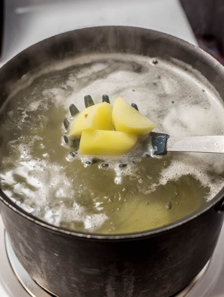 Boiling potato cubes in a large pot of water