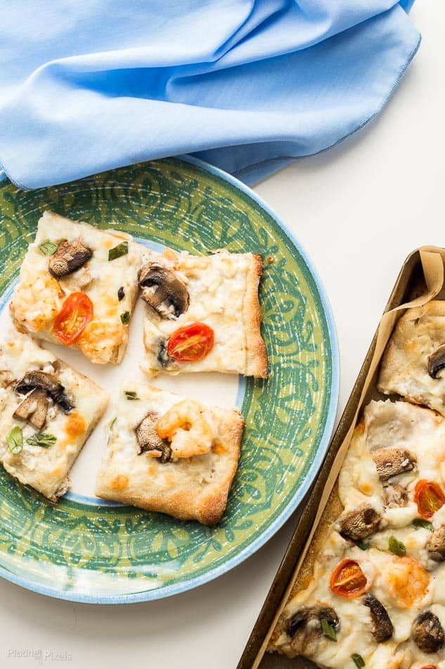 Shrimp Scampi Pizza served on a plate ready to eat