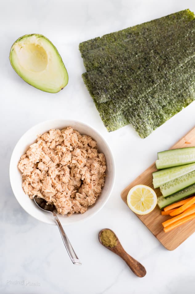 Process shot of ingredients prepped to make Paleo Tuna Salad Wraps on a white surface