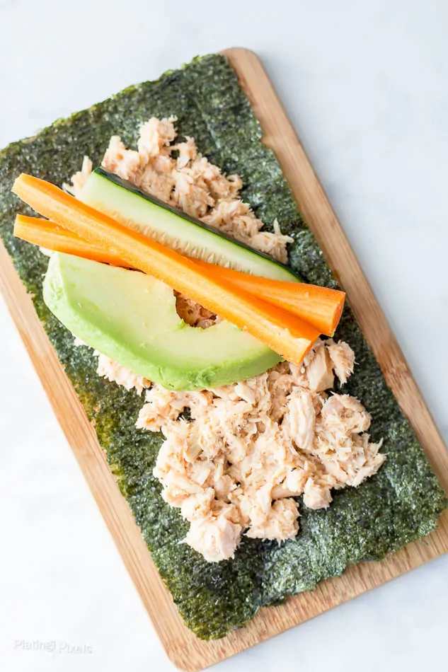 Process shot of ingredients on a nori sheet about to be rolled into Paleo Tuna Wraps