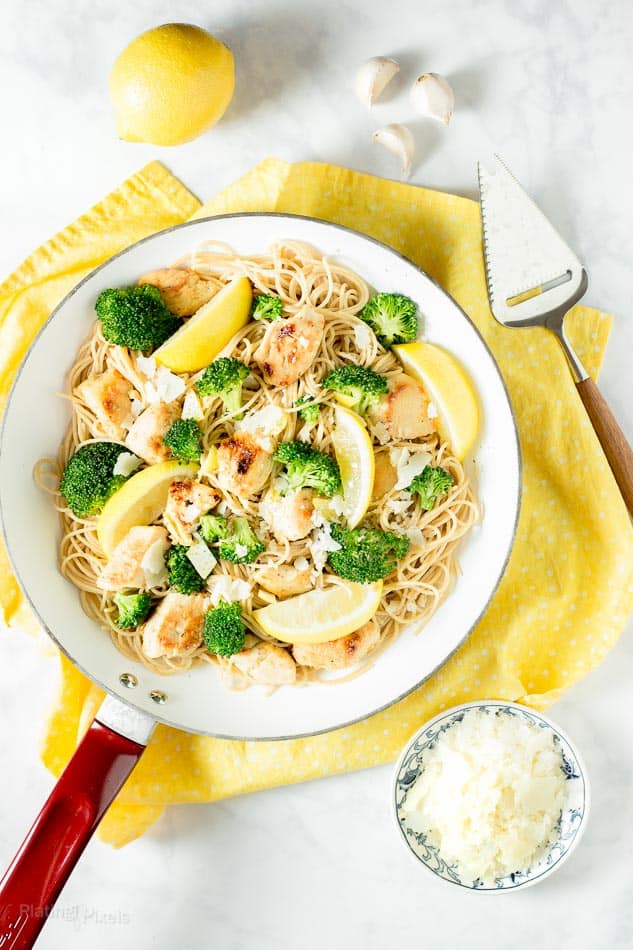 Lemon Broccoli Chicken Pasta in a skillet pan with a yellow dish cloth underneath