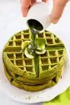 Matcha Green Tea Waffle on a white plate with matcha syrup