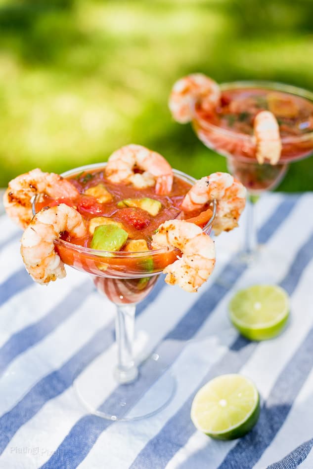 Two Mexican shrimp cocktails served outdoors with grilled shrimp
