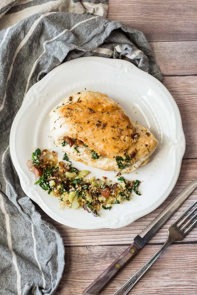 An overhead shot of Apricot and Spinach Stuffed Chicken Breasts on a plate sitting on a wooden surface