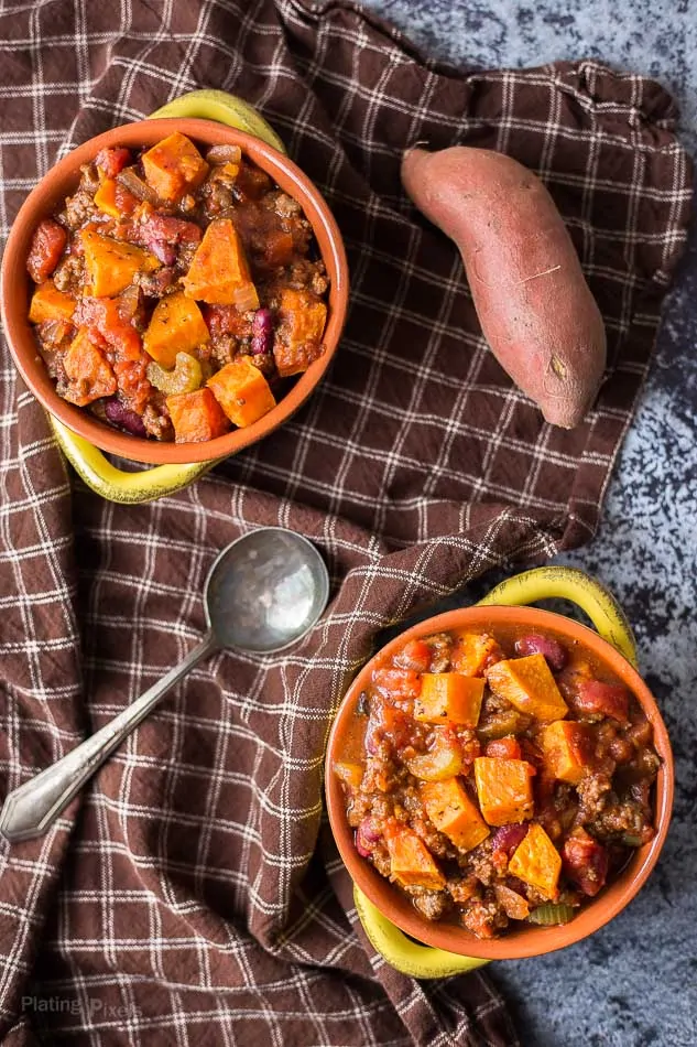 An overhead shot of two bowls of roasted sweet potato chili