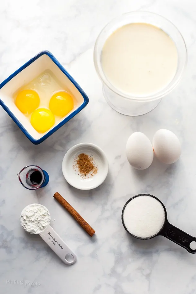 An overhead shot of ingredients on a marble surface for making Homemade Eggnog Pudding