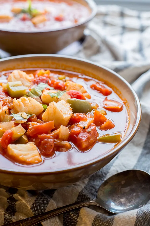 A side shot of an Italian One Pot Cod Fish Soup in a bowl