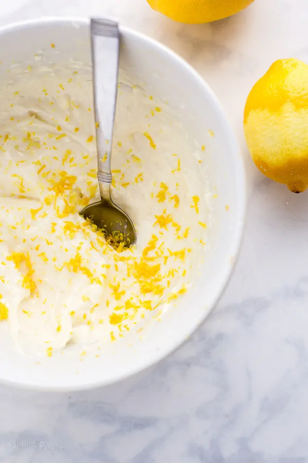 Stirring together lemon cream in a white bowl