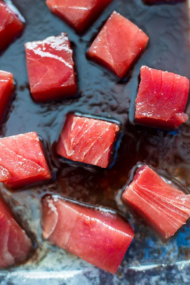 Raw Ahi Tuna squares marinating in sauce