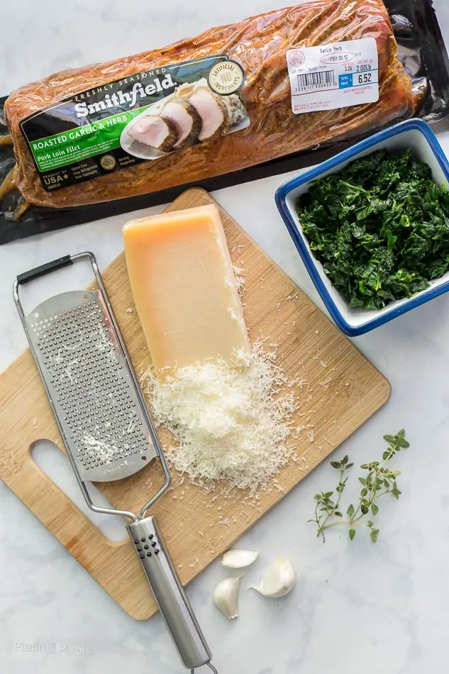 Ingredients for making Spinach Parmesan Stuffed Pork Loin on a worktop