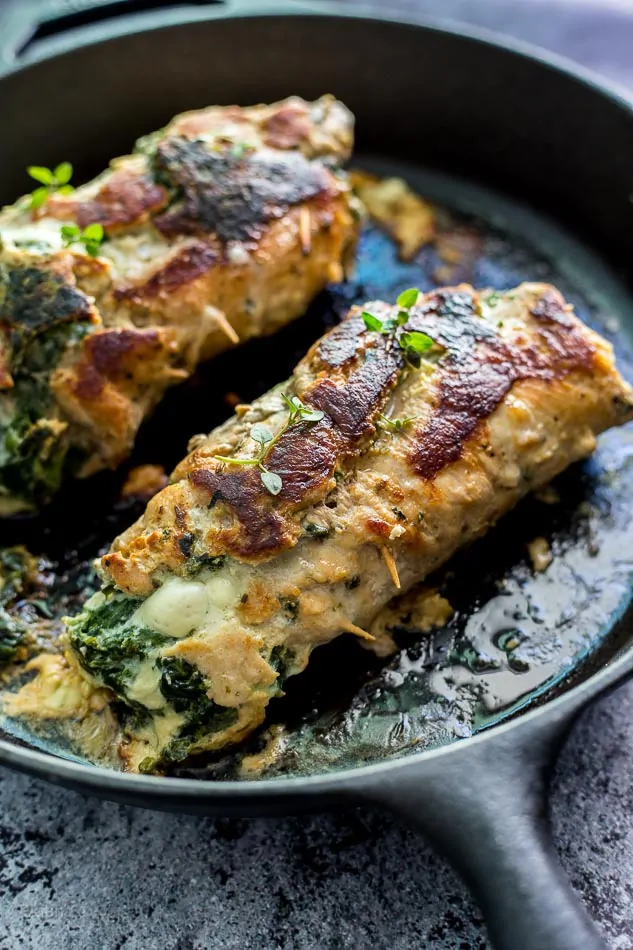 Spinach Parmesan Stuffed Pork Loin cooking in a skillet pan