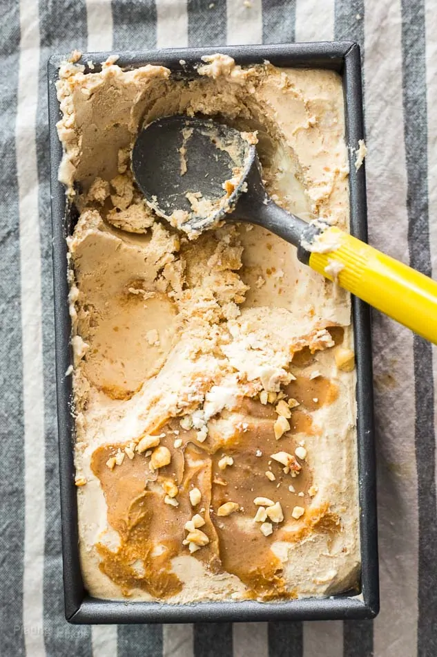 No Churn Peanut Butter Ice Cream in a container with scoops taken out of it