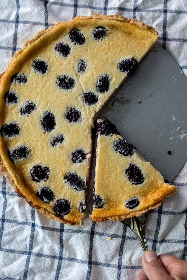 An overhead shot of a Blackberry Custard Pie cut into slices