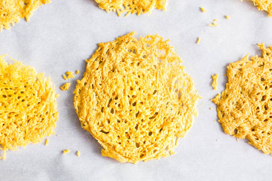 An overhead shot of Curried Parmesan Crisps on a baking tray
