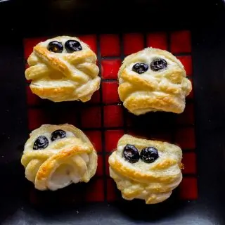 Halloween Puff Pastry Mummy Cheese Wheels recipe | platingpixels.com
