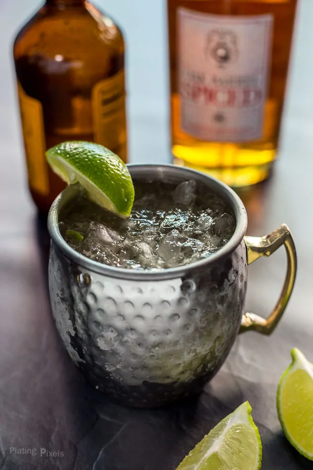 Prepared Caribbean Mule in a copper mug garnished with lime wedge (Moscow Mule with rum)