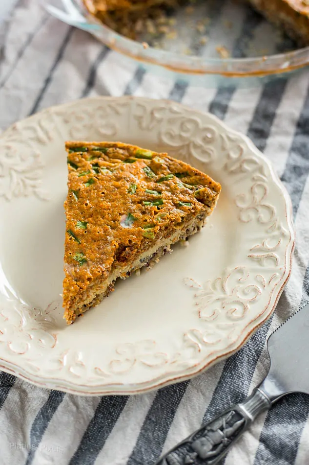 Slice of Chorizo and Cheddar Quiche with Quinoa Crust on a plate