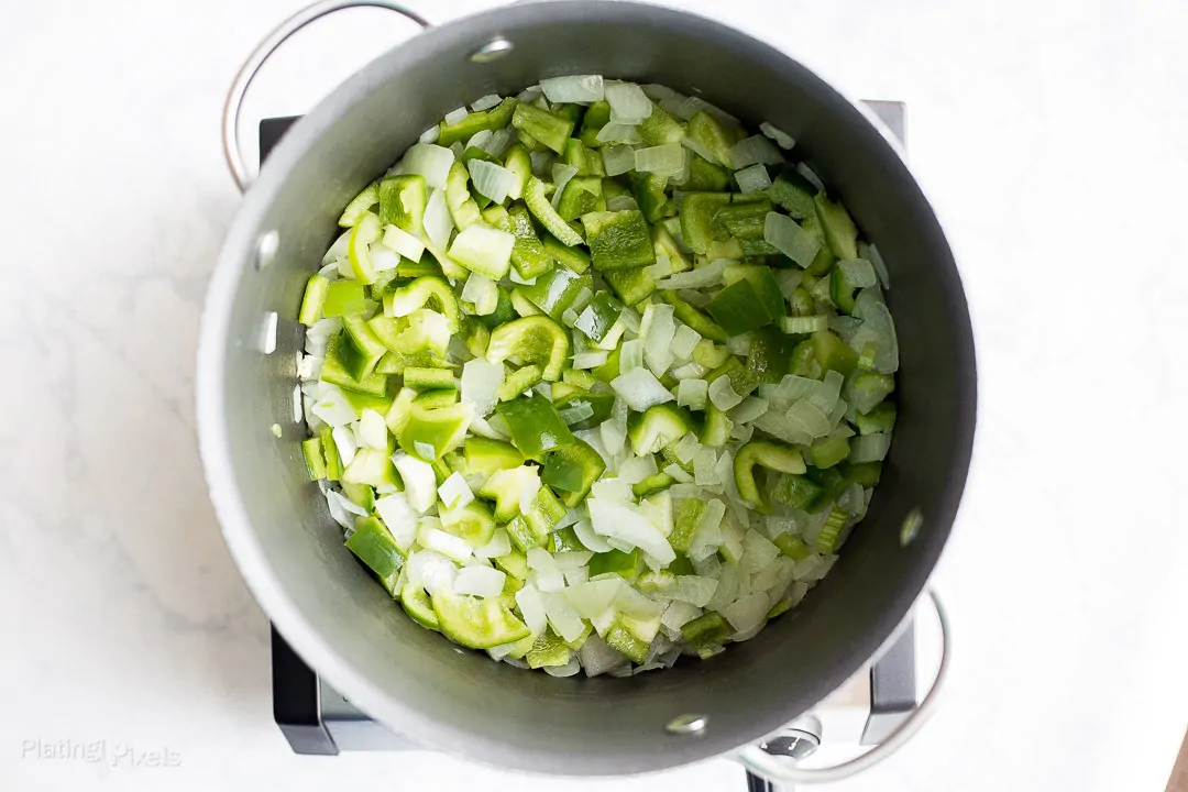 Process shot of sautéing onion, celery, and bell peppers