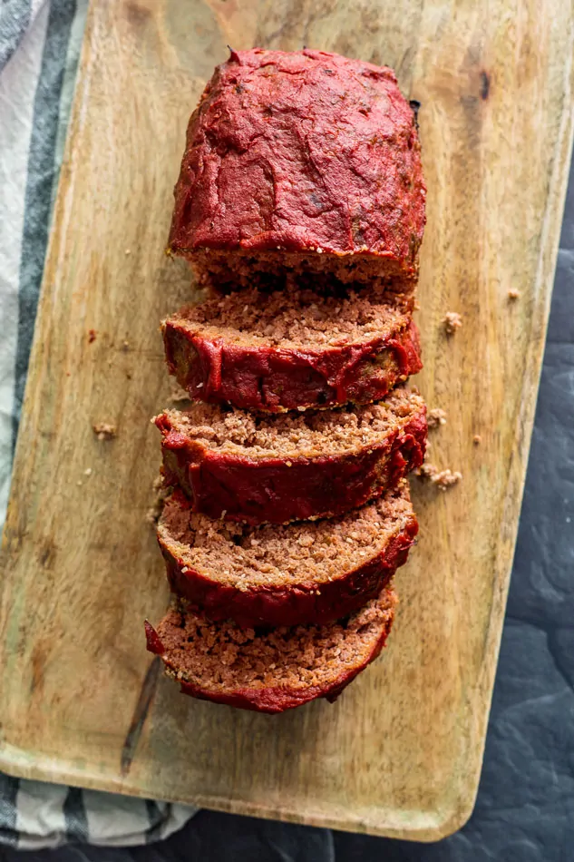 Glazed, cooked sous vide meatloaf on cutting board in slices