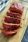 Cooked Moist Sous Vide Meatloaf slices on a wooden cutting board