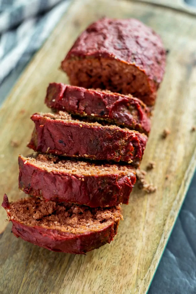 Cooked Moist Sous Vide Meatloaf slices on a wooden cutting board