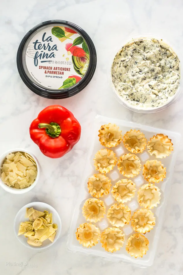 Ingredients for making Mini Parmesan Spinach Phyllo Cup Appetizers on a marble surface