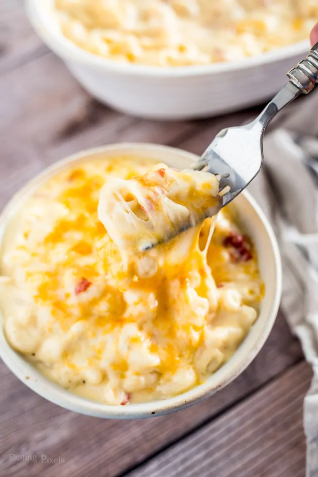 Gluten-Free Mac and Cheese in a white bowl with a fork picking some up