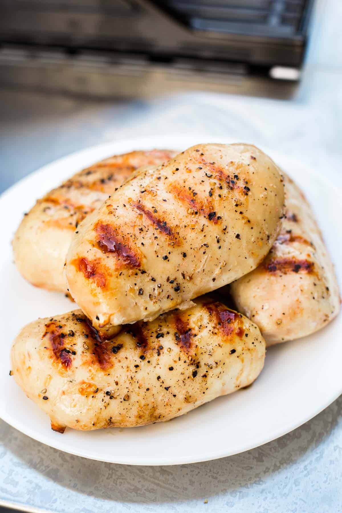 Plate of perfectly cooked grilled chicken breast