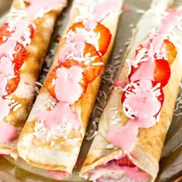 Three Dairy Free Crepes with Strawberry Coconut Sauce on a plate