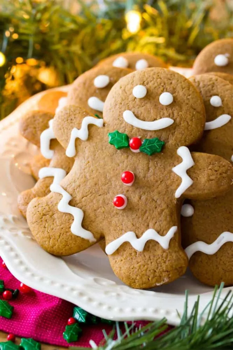 Close up of gingerbread man decorated Christmas cookies on a plate