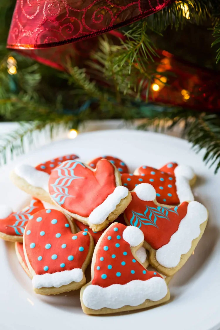 Hat and Mittens Cut Out Decorated Christmas Cookies on a plate