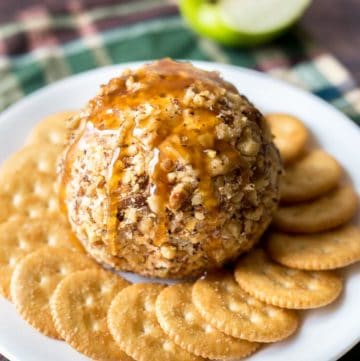 Caramel Apple Cheese Ball on plate surrounded by crackers
