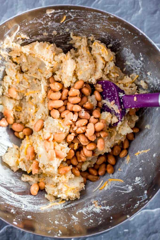 Mixing filling for Carnitas Loaded Potato Skins in a metal bowl