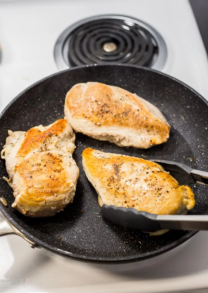 Browning turkey breasts in pan on stove