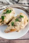 Close up of two slow cooked turkey breasts smothered in marsala sauce on a plate on table