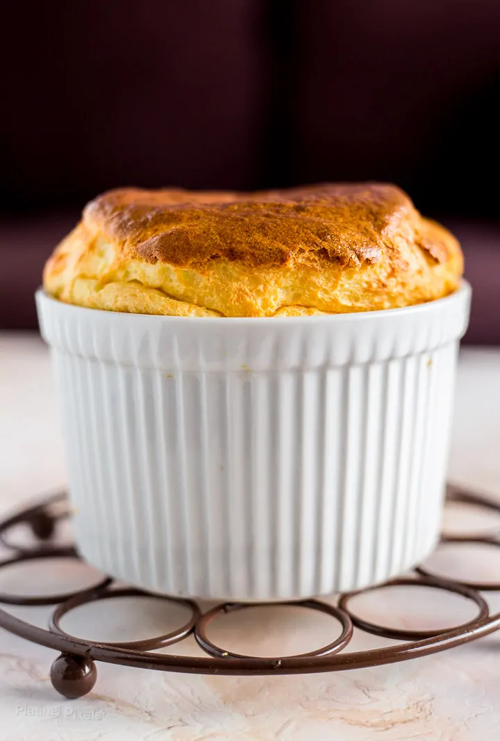 Side shot of Easy Cheese Souffle with Brie Cheese sitting on cooling rack