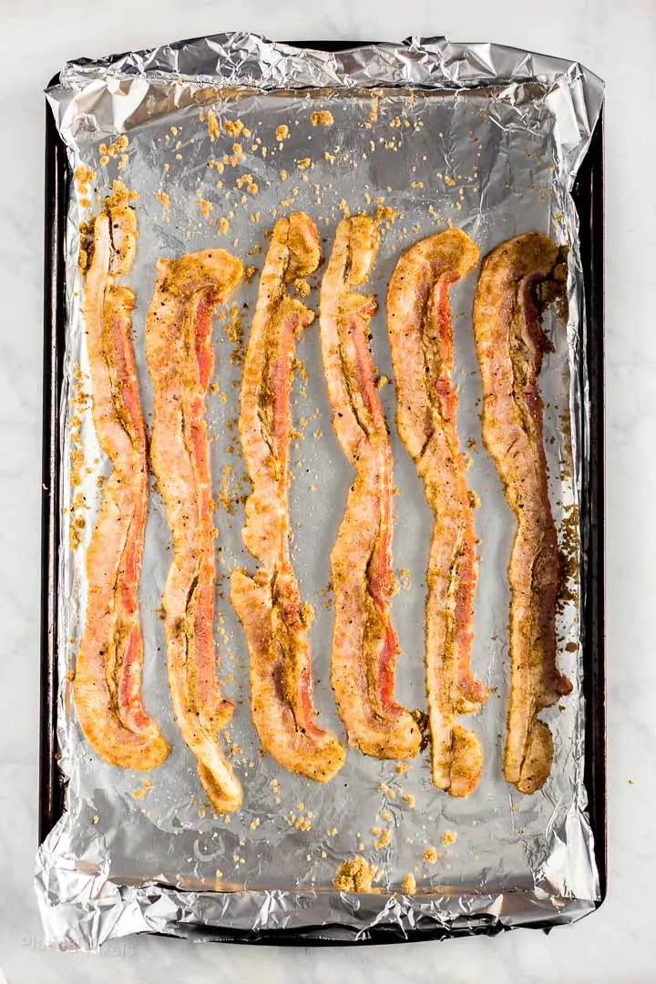 Bacon coated in brown sugar prepared on a baking sheet