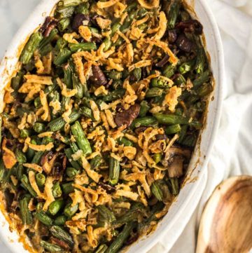 Overhead shot of cooked String Bean Casserole with Candied Bacon in a oval casserole dish