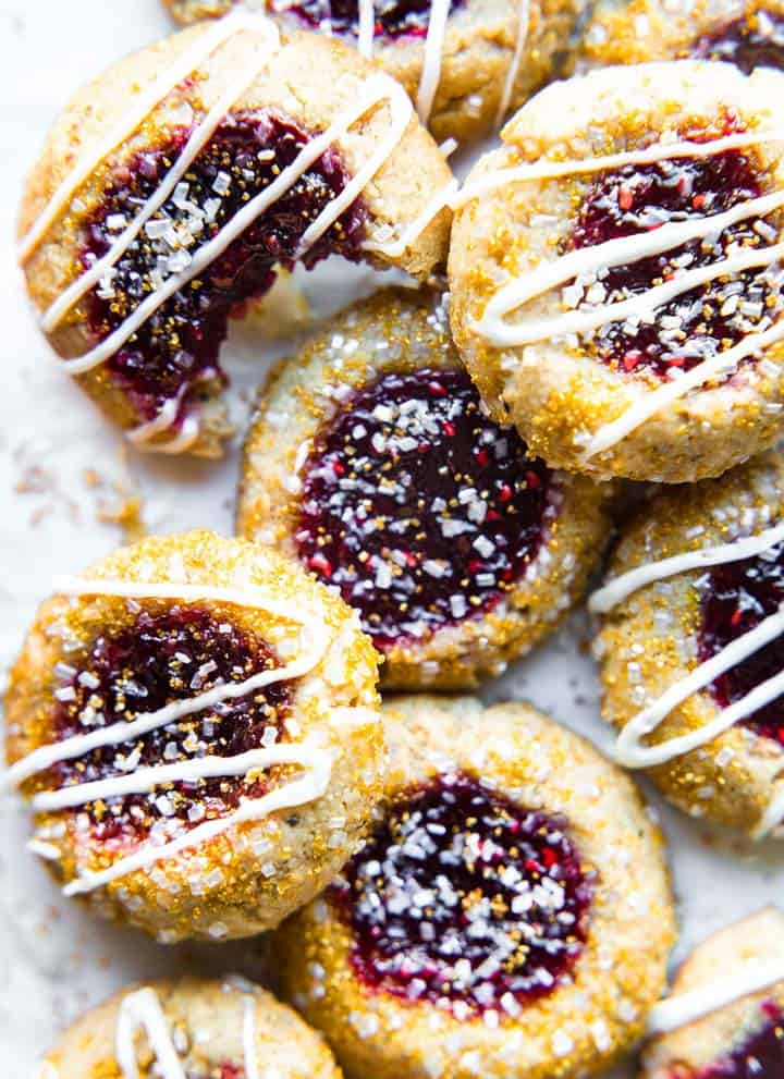 Pile of thumbprint cookies with drizzle glaze