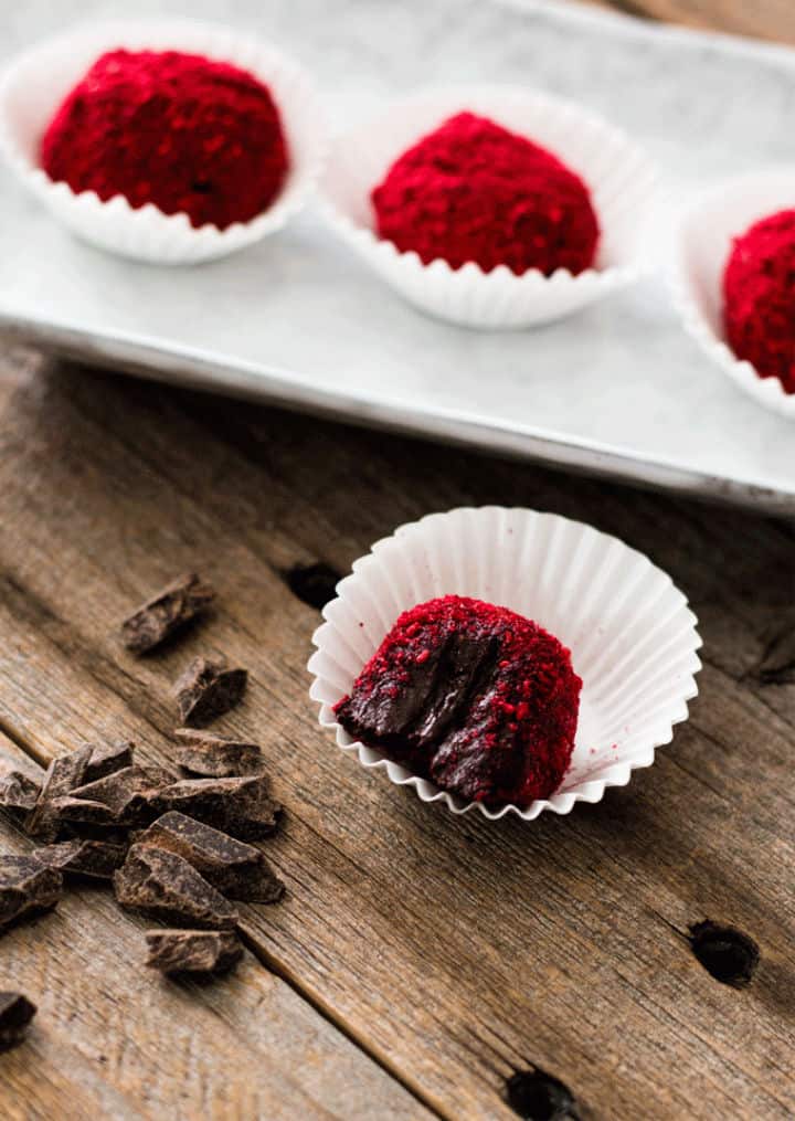 Chocolate Raspberry Truffles sitting in paper holders - Roundup of Romantic Chocolate Desserts for Valentine's Day