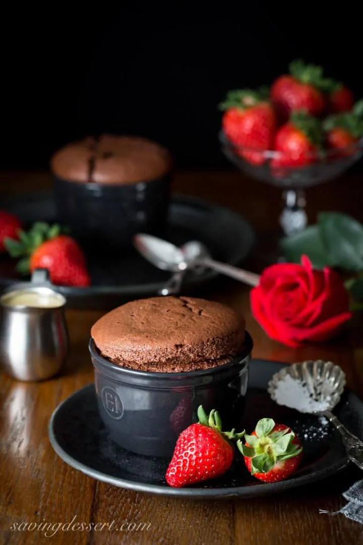Chocolate Souffle with Baileys Creme Anglaise in a black ramekin - Roundup of Romantic Chocolate Desserts for Valentine's Day